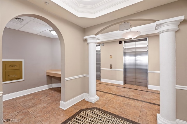 corridor with ornate columns, visible vents, arched walkways, baseboards, and elevator
