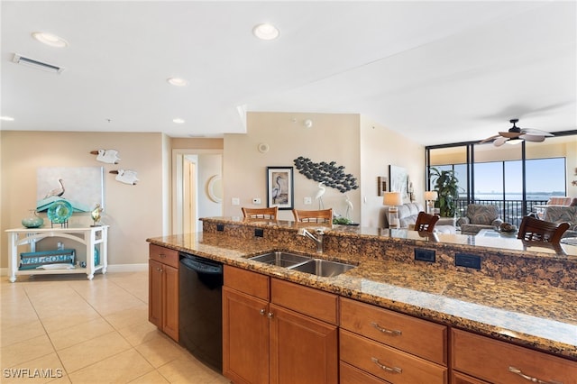 kitchen with black dishwasher, open floor plan, a sink, and stone counters