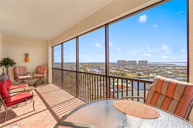 sunroom / solarium with a city view and a water view