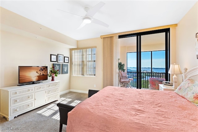 bedroom featuring ceiling fan, a water view, baseboards, access to outside, and carpet