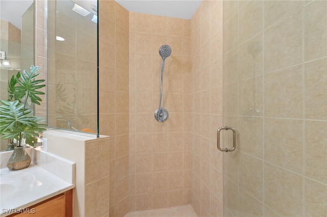 bathroom with a stall shower and vanity