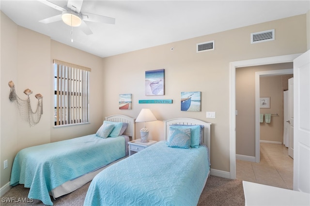 bedroom with a ceiling fan, visible vents, baseboards, and light tile patterned floors