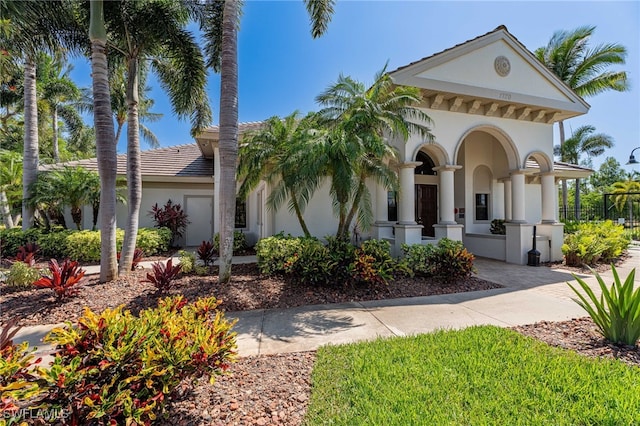 view of front of house with a tile roof and stucco siding