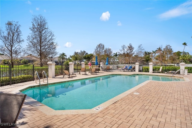 community pool featuring a patio area and fence