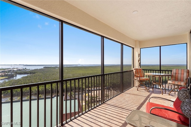 sunroom with a water view