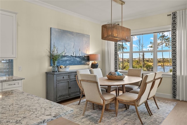 dining room with crown molding and baseboards