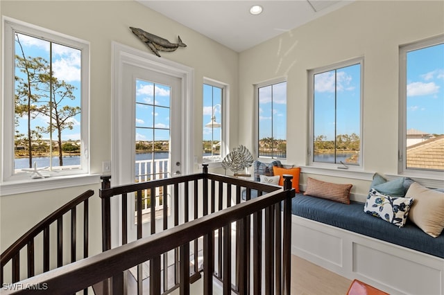 sunroom / solarium featuring a water view