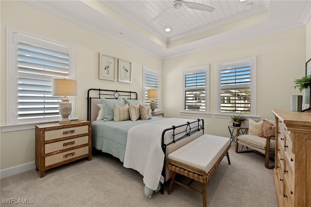 bedroom featuring baseboards, light colored carpet, a tray ceiling, crown molding, and recessed lighting