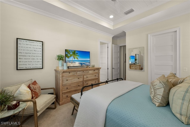 carpeted bedroom featuring a tray ceiling, recessed lighting, visible vents, and crown molding