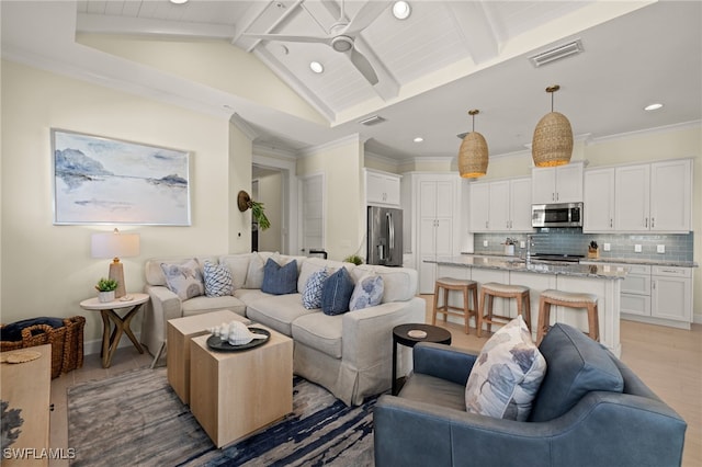 living area featuring lofted ceiling with beams, ceiling fan, visible vents, and crown molding