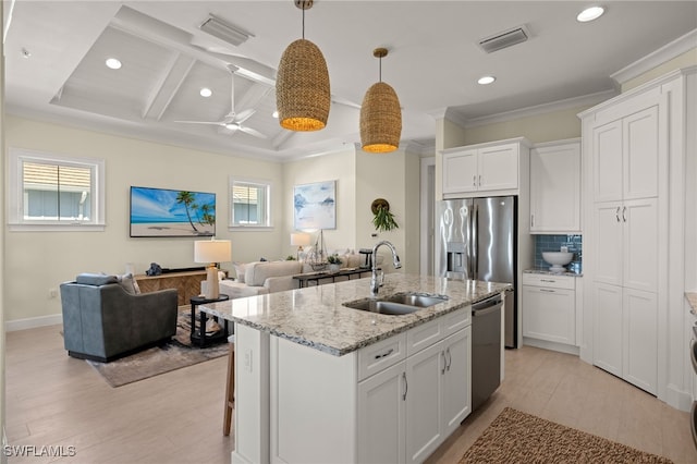 kitchen featuring visible vents, appliances with stainless steel finishes, backsplash, and a sink