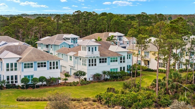 birds eye view of property featuring a residential view and a wooded view