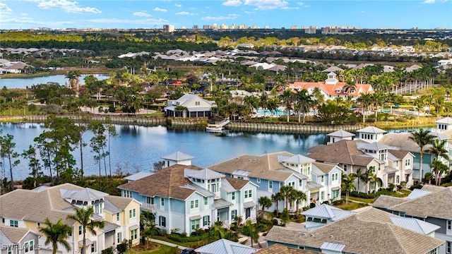 drone / aerial view with a water view and a residential view