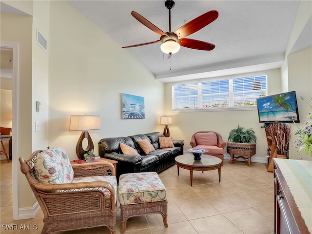 living room featuring light tile patterned floors, ceiling fan, a textured ceiling, and lofted ceiling