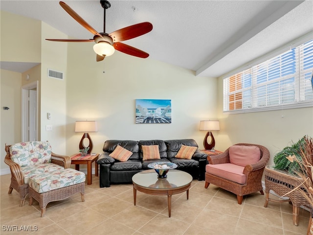 tiled living room featuring lofted ceiling, ceiling fan, and a textured ceiling