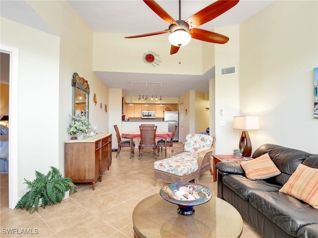 living room with rail lighting, ceiling fan, and light tile patterned flooring