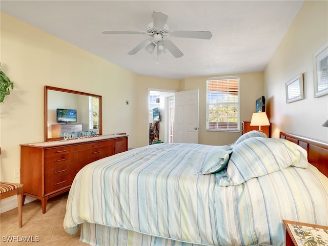 tiled bedroom featuring ceiling fan