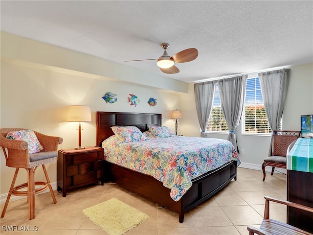 tiled bedroom featuring ceiling fan and a textured ceiling