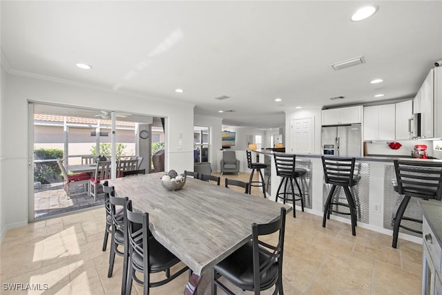 dining room featuring stone tile flooring, baseboards, and recessed lighting