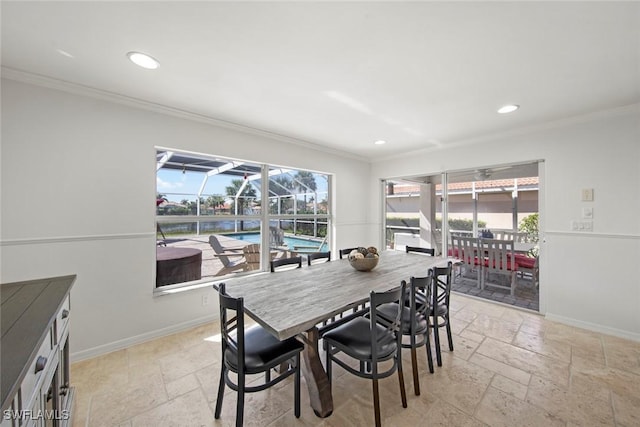 dining area with baseboards, stone tile floors, and ornamental molding