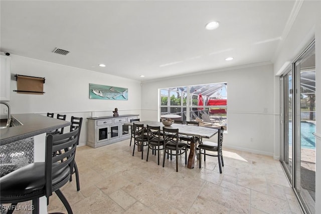 dining area with visible vents, crown molding, stone tile floors, and recessed lighting