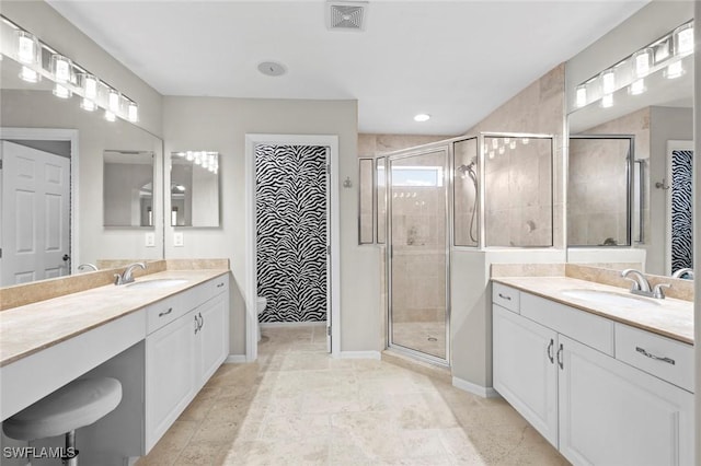 full bath with a sink, two vanities, visible vents, and a shower stall