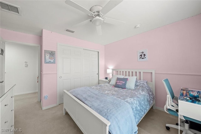 bedroom featuring a ceiling fan, a closet, light colored carpet, and visible vents