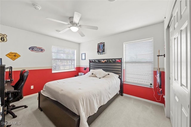 carpeted bedroom featuring baseboards, a closet, and ceiling fan