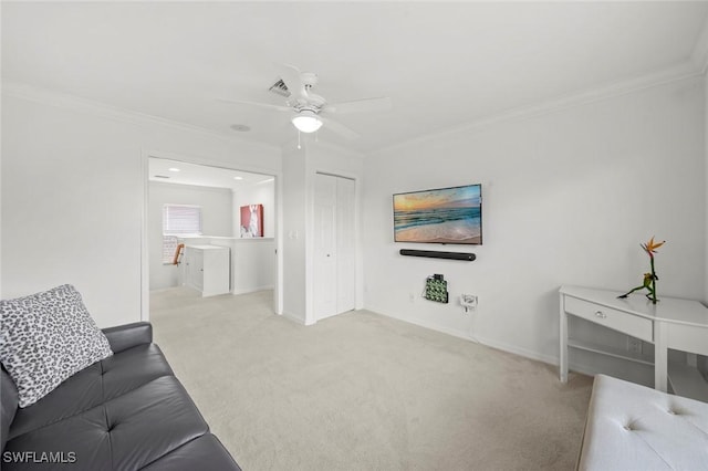 living area featuring baseboards, carpet floors, a ceiling fan, and crown molding