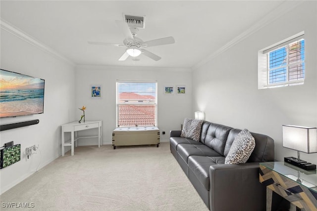 living area with crown molding, light colored carpet, baseboards, visible vents, and a ceiling fan