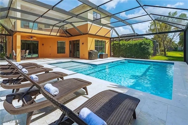 pool with a lanai and a patio area