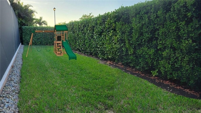 13789 Callisto Ave, Naples, FL 34109 - view of green lawn featuring a playground