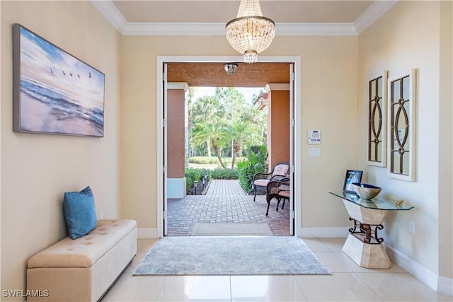 tiled entrance foyer featuring an inviting chandelier, baseboards, and crown molding