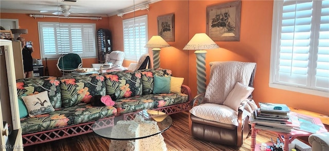 living room featuring ornamental molding, ceiling fan, and wood-type flooring