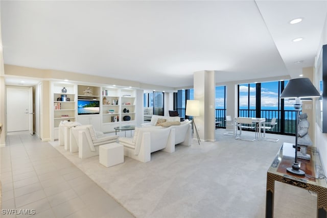 living room with light carpet, light tile patterned floors, expansive windows, built in shelves, and recessed lighting