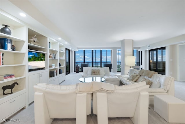 living area featuring expansive windows, light carpet, and recessed lighting