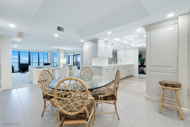 dining area featuring recessed lighting, a raised ceiling, visible vents, and light tile patterned floors