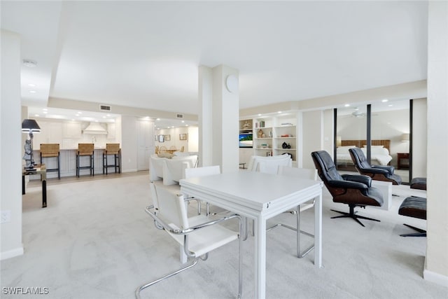 dining space with light carpet, built in shelves, visible vents, and recessed lighting