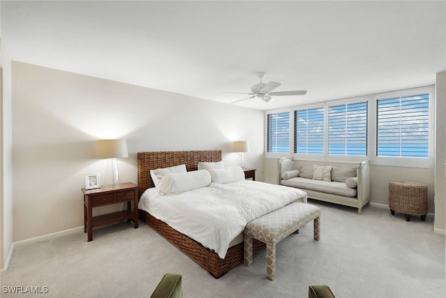 bedroom with baseboards, a ceiling fan, and light colored carpet