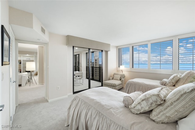 bedroom with light carpet, access to outside, visible vents, and baseboards