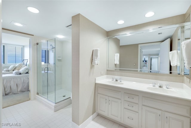 bathroom featuring ensuite bathroom, double vanity, a sink, and a shower stall