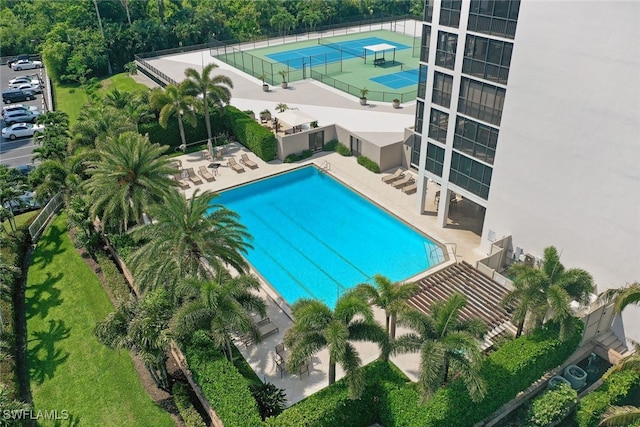 community pool featuring a patio area and fence