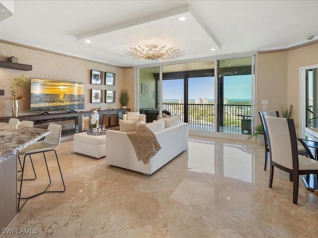 living area featuring marble finish floor, ornamental molding, a wall of windows, and recessed lighting