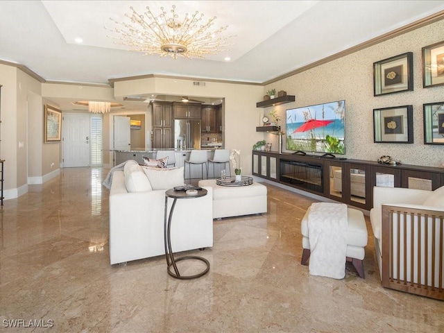 living room featuring a chandelier, marble finish floor, ornamental molding, and baseboards