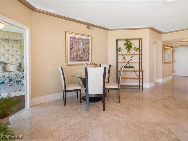 dining area with ornamental molding, visible vents, and baseboards