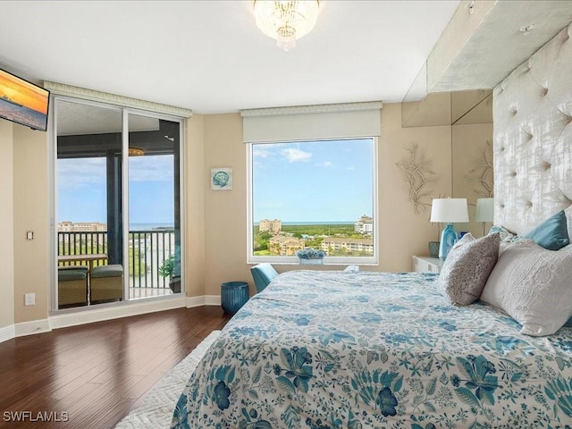 bedroom featuring access to outside, floor to ceiling windows, baseboards, and dark wood-style flooring