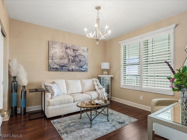 living room with an inviting chandelier, baseboards, and dark wood-style flooring