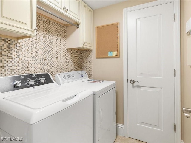 clothes washing area featuring washer and clothes dryer and cabinet space