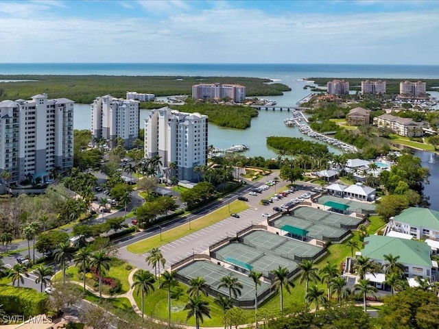 birds eye view of property with a water view and a city view