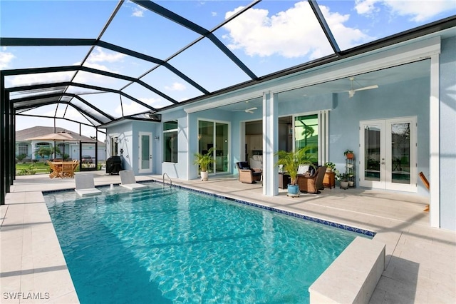 outdoor pool with a ceiling fan, french doors, glass enclosure, and a patio